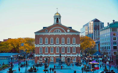 Faneuil Hall on the Boston Freedom Trail, bustling with visitors on a self-guided audio walking tour.