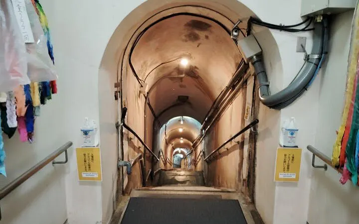 Narrow underground tunnel leading to Okinawa’s WWII Navy Headquarters in Naha.