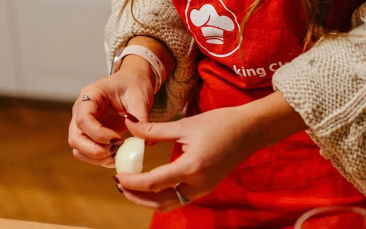 Person peeling an egg during a Hungarian cooking class in Budapest.