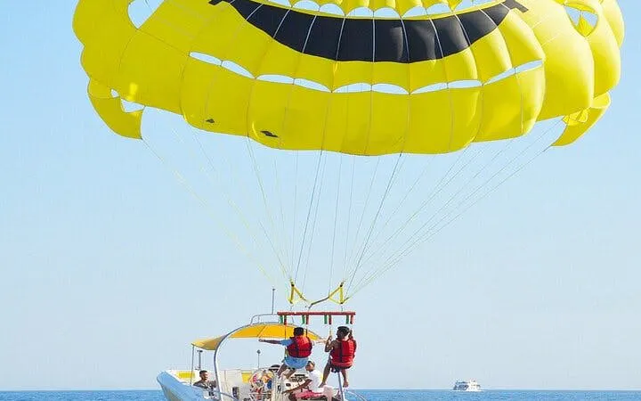 Parasailing over the Red Sea with a yellow parachute, departing by speedboat in Hurghada.