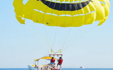 Parasailing over the Red Sea with a yellow parachute, departing by speedboat in Hurghada.