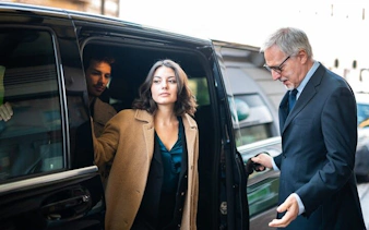 Private transfer service with passengers exiting a vehicle in Marrakesh.