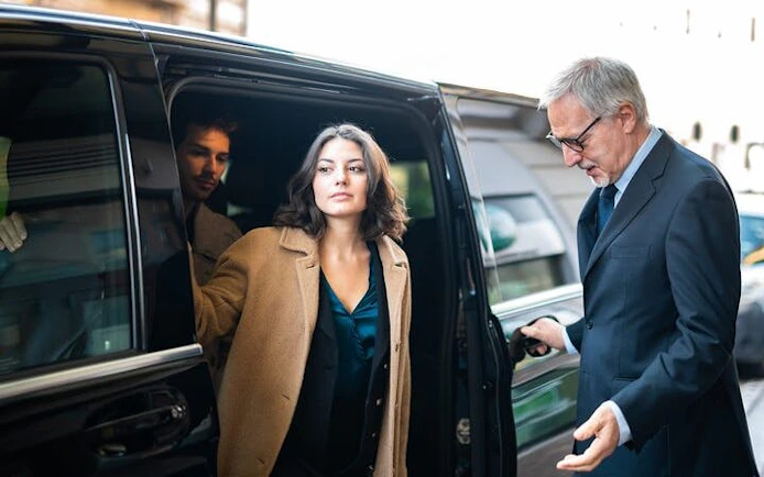 Private transfer service with passengers exiting a vehicle in Marrakesh.