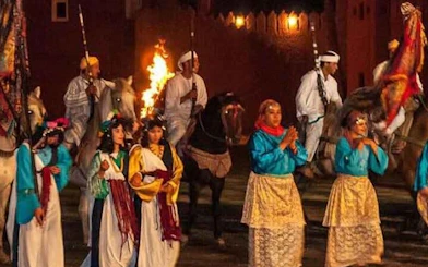 Performers in traditional attire at Chez Ali Folklore Show, Marrakesh.