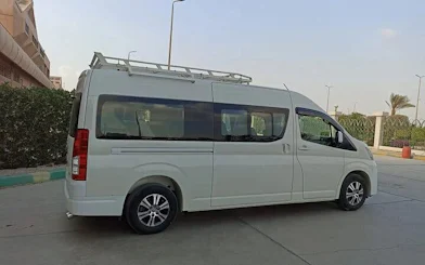 Van for personalized airport transfer service in Hurghada, parked near hotel.