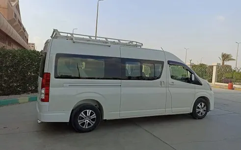 Van for personalized airport transfer service in Hurghada, parked near hotel.