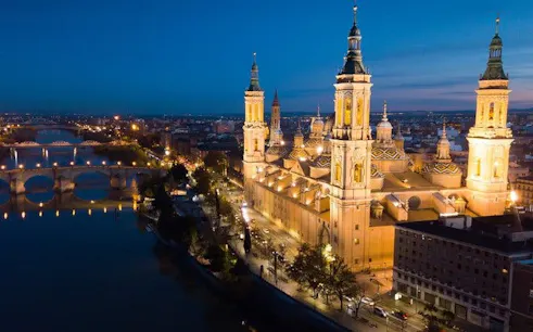 Basilica of Our Lady of the Pillar illuminated at night, Zaragoza, Spain.