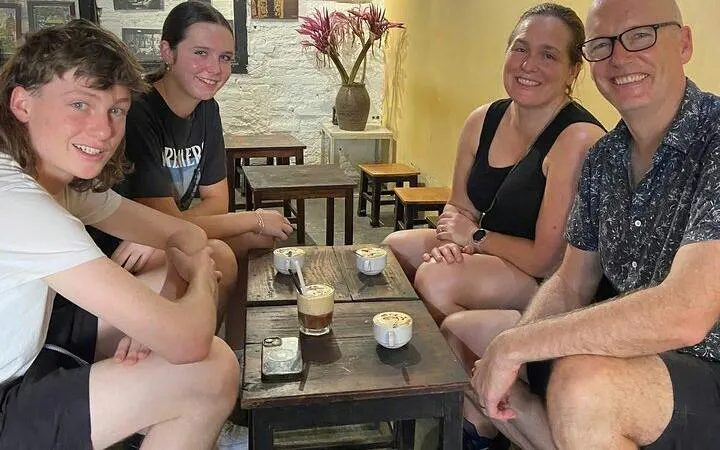 Group enjoying egg coffee at a Hanoi café during motorbike tour.