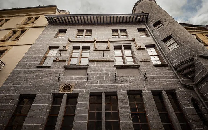 Historic building facade in Geneva, part of the self-guided city exploration game.