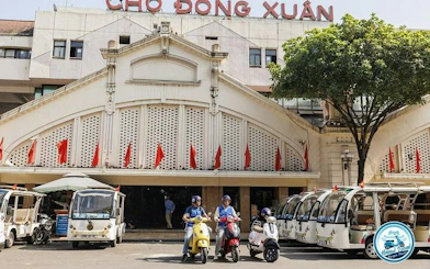 Vespa riders in front of Dong Xuan Market, Hanoi, during a half-day tour.