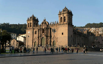Cusco Cathedral with tourists in the historic center during a self-guided audio walking tour.
