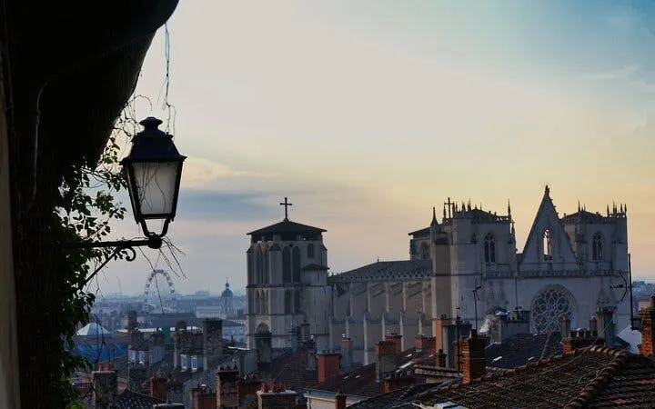 Lyon skyline with Gothic cathedral at sunset, part of Haunted Lyon exploration game.