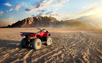 ATV quad bike on desert landscape at sunset, Sharm El Sheikh.