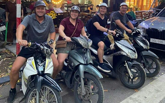Tourists on motorbikes ready for Hanoi nightlife and street food tour.