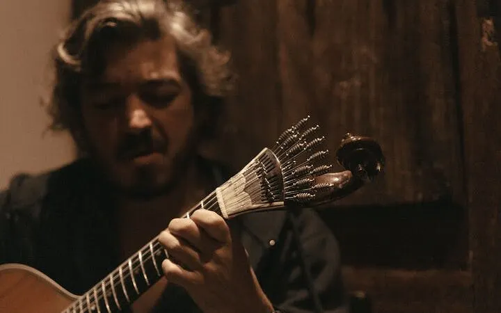 Musician playing Portuguese guitar during Fado show at Mesa de Frades Chapel, Lisbon.