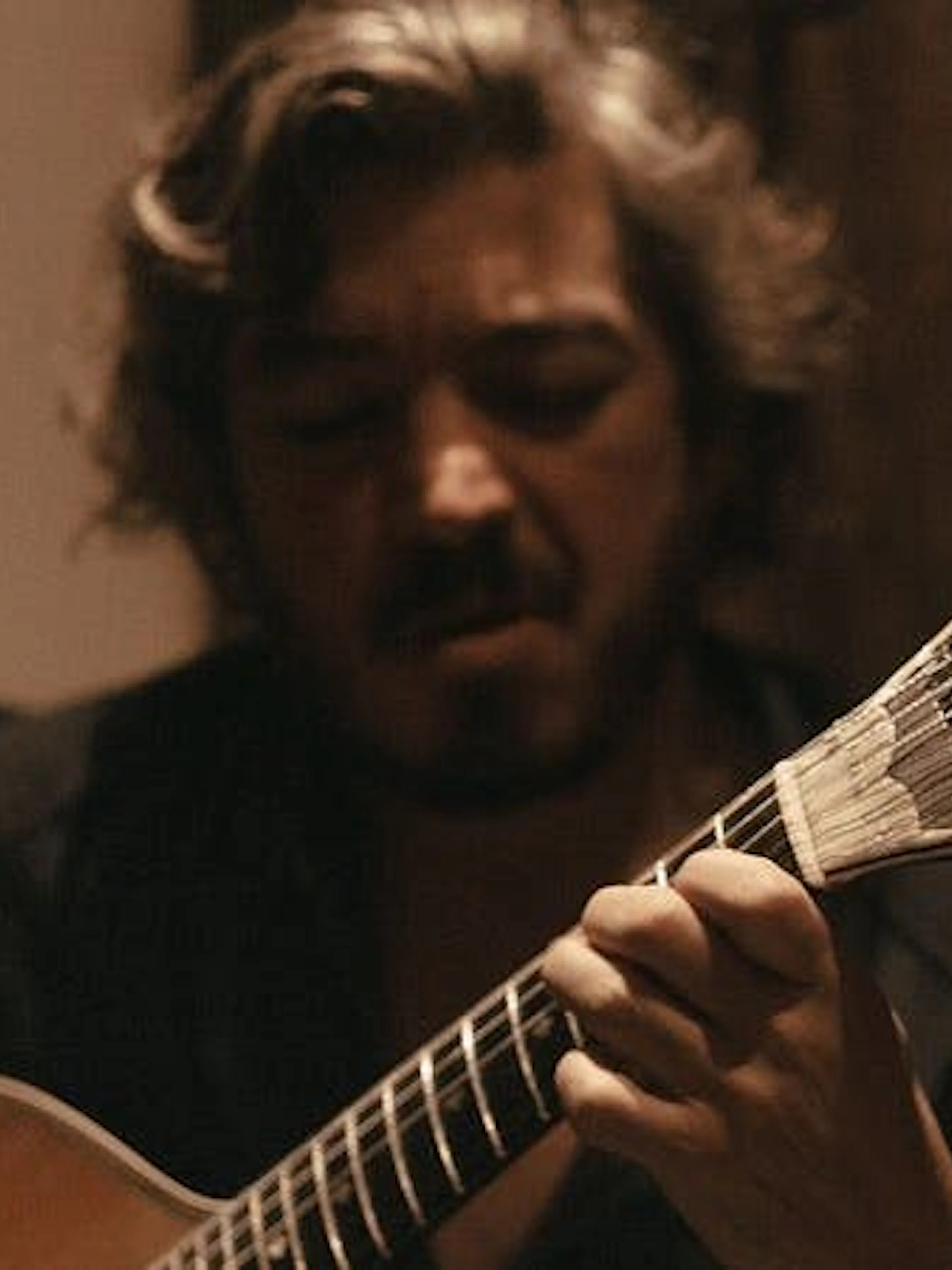 Musician playing Portuguese guitar during Fado show at Mesa de Frades Chapel, Lisbon.