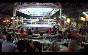 Muay Thai match at Thapae Stadium, Chiang Mai, with audience watching.