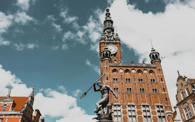 Neptune Fountain and Gdansk Town Hall on a self-guided audio walking tour in Gdansk Old Town.