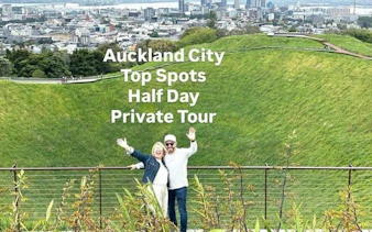 Couple enjoying view from Mount Eden with Auckland cityscape in background.