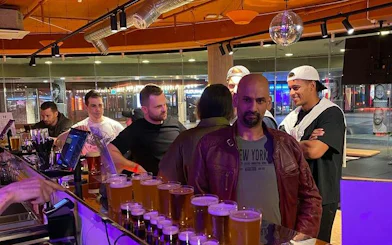 Group enjoying drinks at a bar during a Stockholm pub crawl.