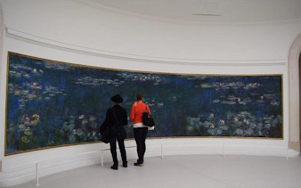 Visitors viewing Monet's Water Lilies at Musée de l'Orangerie, Paris.