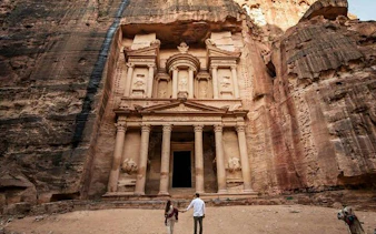 Couple exploring the ancient rock-carved Treasury in Petra during a full-day tour from Sharm El Sheikh.