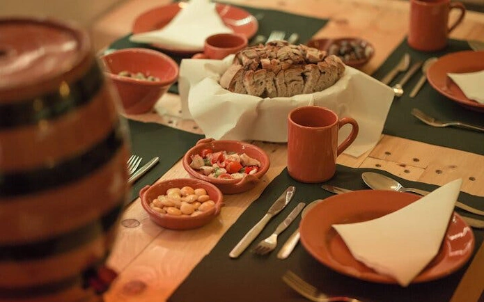 Portuguese dinner setup with traditional dishes at a Roman theatre venue in Lisbon.
