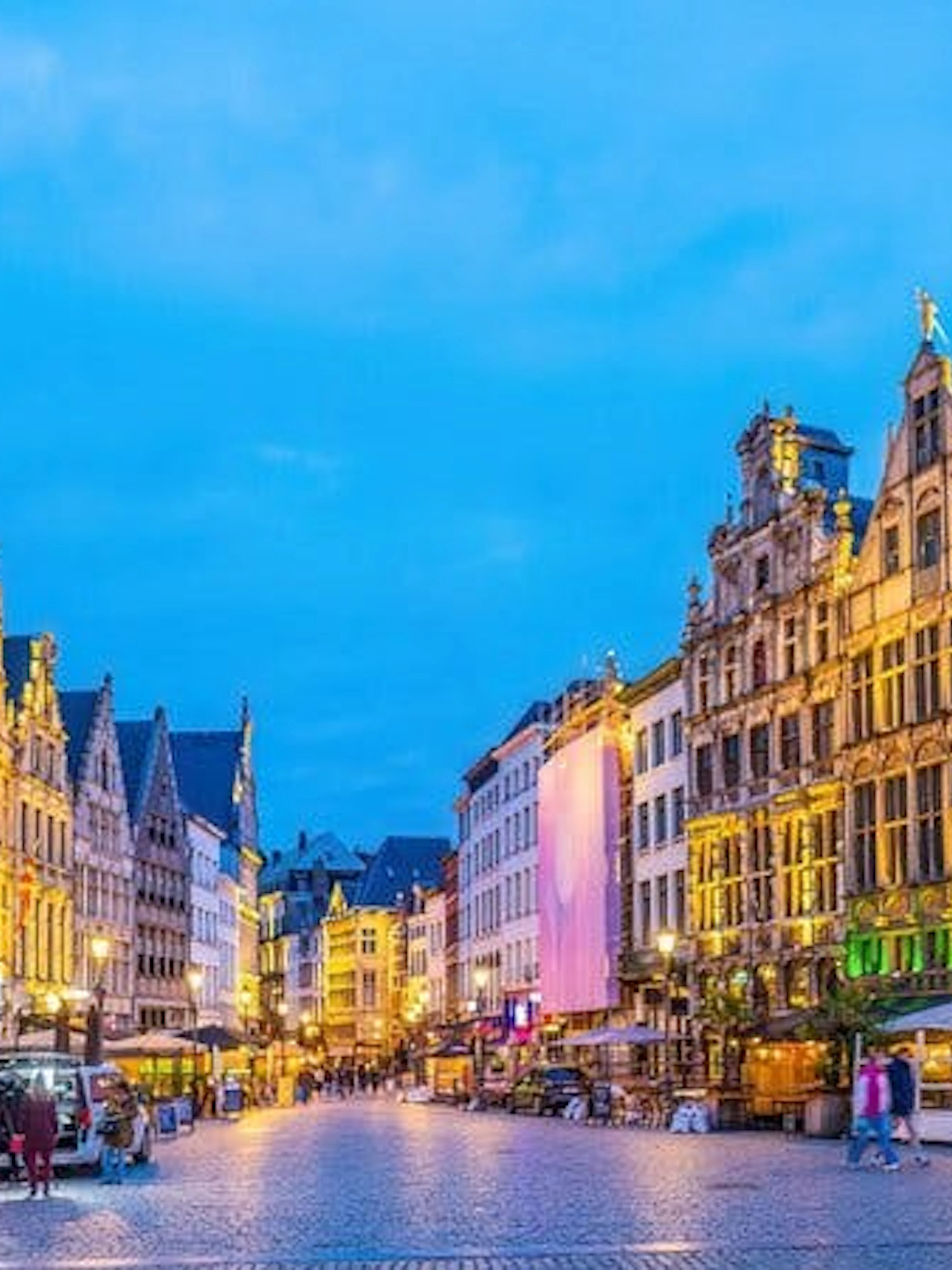 Antwerp city square with historic buildings during evening, part of self-guided walking tour.