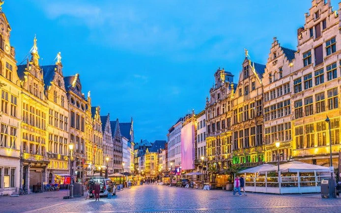 Antwerp city square with historic buildings during evening, part of self-guided walking tour.