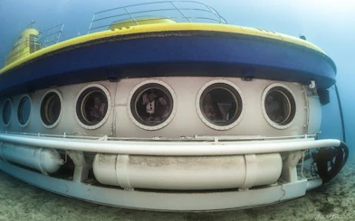 Submarine underwater in Tenerife with visible portholes, part of Los Gigantes tour.