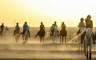 Horseback riders in desert at sunset, Sharm El Sheikh tour.