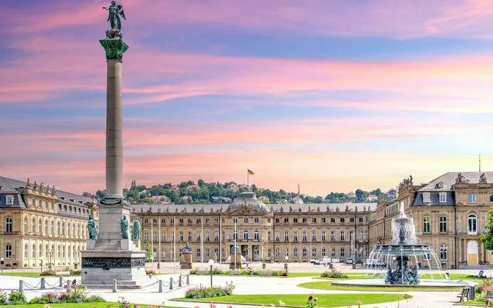 Schlossplatz with Jubilee Column and fountain in Stuttgart during sunset.