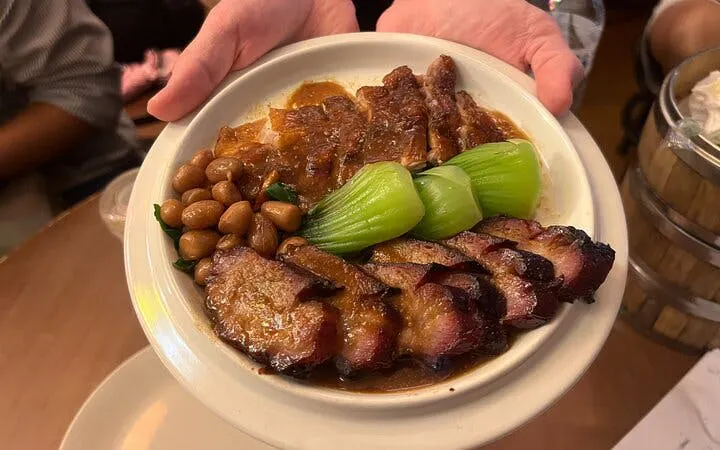Plate of roasted meats, bok choy, and peanuts on Bangkok Michelin Foodie Tour in Chinatown.