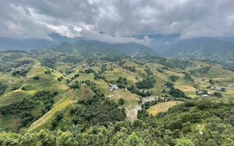 Terraced rice fields in Sa Pa with misty mountains in the background, Vietnam.
