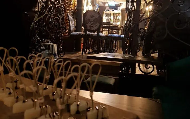 Cheese samples on skewers in a cozy London wine bar during a guided tasting tour.