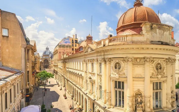 Historic architecture along a cobblestone street in Bucharest, Romania, featured in a self-guided walking tour.