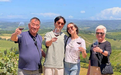 Group enjoying wine tasting at a Tuscan vineyard on Pisa and Vinci day tour.