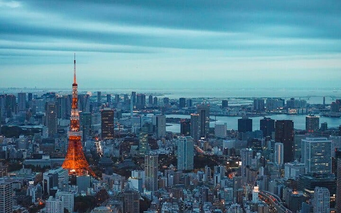 Tokyo skyline with illuminated Tokyo Tower at dusk, viewed from the Tokyo City View Observation Deck.