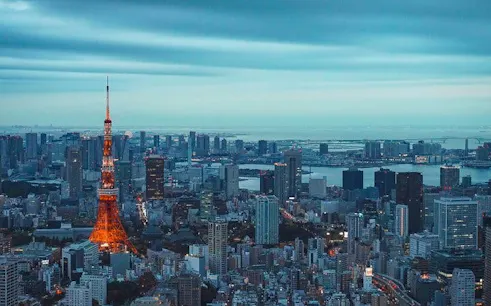 Tokyo skyline with illuminated Tokyo Tower at dusk, viewed from the Tokyo City View Observation Deck.