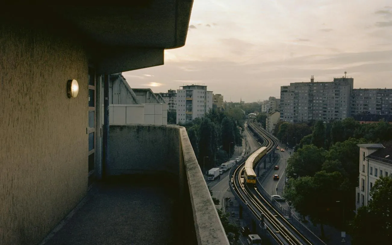 View of Berlin's elevated train tracks and cityscape from a balcony in Kreuzberg.