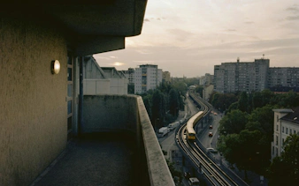 View of Berlin's elevated train tracks and cityscape from a balcony in Kreuzberg.