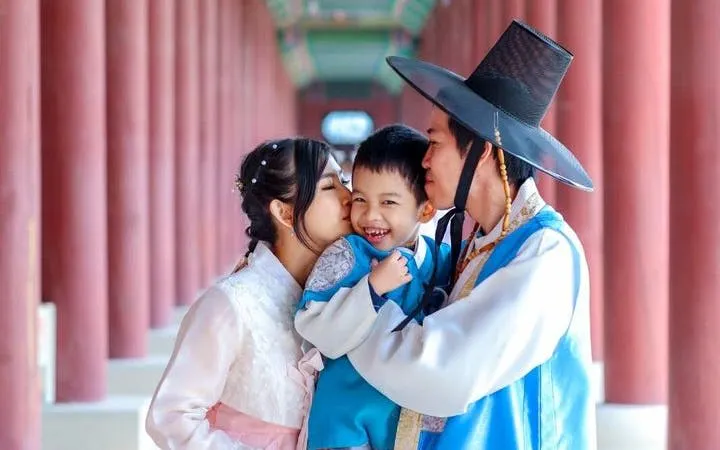 Family in traditional Hanbok at Gyeongbokgung Palace, Seoul, during a private photoshoot.