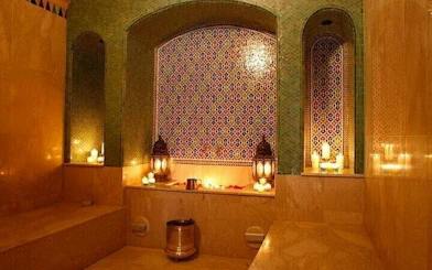 Moroccan hammam with mosaic tiles and lanterns in Marrakesh.