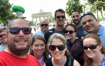 Group of tourists in front of Brandenburg Gate, Berlin, on a self-guided walking tour.