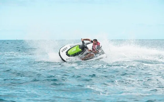 Jet ski rider making a sharp turn on open water during Marrakesh aqua adventure tour.