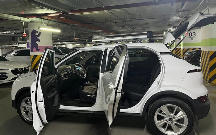 Private car in a parking garage for Sapa to Ha Noi transfer with open doors.