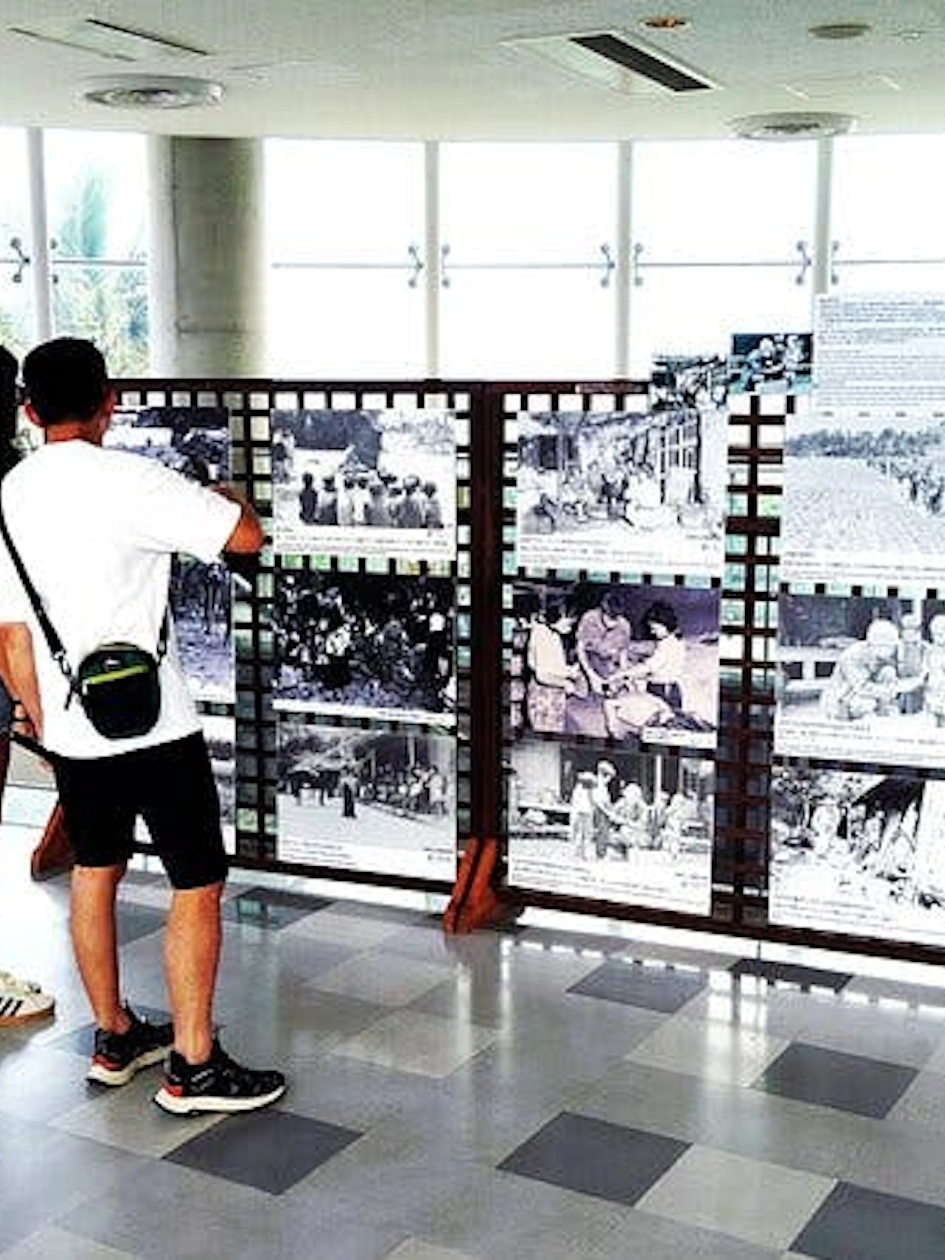 Visitors viewing historical WWII photos at Okinawa Navy Underground HQ in Naha.
