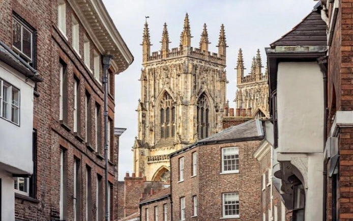 York Minster viewed from a narrow street, part of a self-guided walking tour on mobile app.