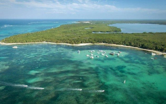 Boats anchored near lush coastline at Miches Natural Reserve, Punta Cana.