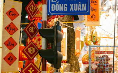 Dong Xuan market sign with traditional Vietnamese decorations, Hanoi Old Quarter.